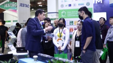 Visitors at a booth at BEX Asia